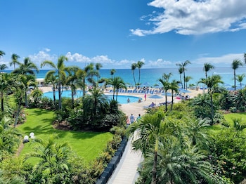 On the beach, white sand, sun loungers, beach umbrellas