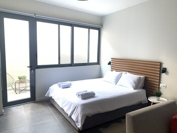 Habitación cuádruple Deluxe | Vista a la ciudad