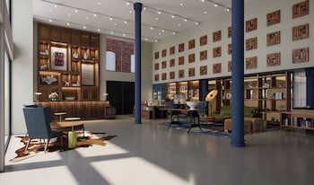 Enjoy a drink at the bar, surrounded by a comfortable seating area and views of the building's exterior.