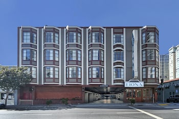 A hotel entrance with a sign reading "HOTEL FIONA," a parking garage, and a red brick facade.