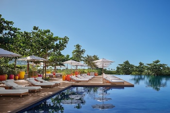 On the beach, white sand, beach cabanas, sun loungers
