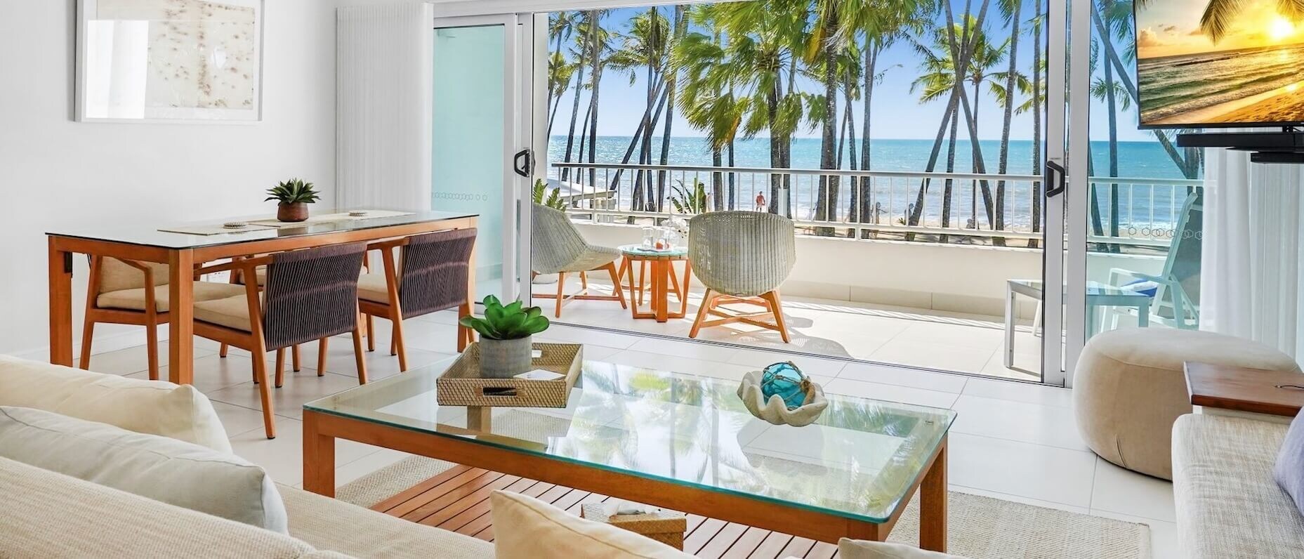 A modern apartment with an ocean view with palm trees