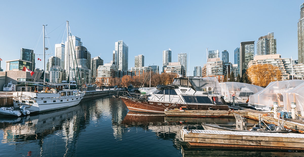 Cityscape of Toronto, Canada, showing a cluster of modern high-rise buildings under a bright sky