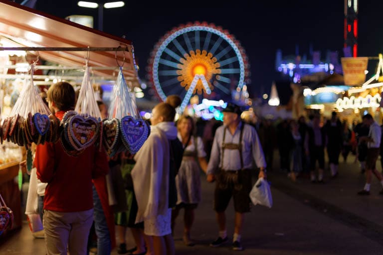 People enjoying the evening celebrations and market stalls at Munich's Oktoberfest.
