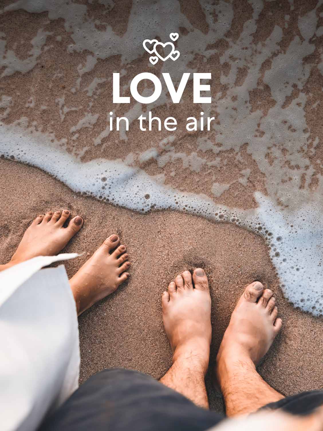 Point a view of a man and woman looking down at their feet in the sand - just at the water's edge. A superimposed title reads: Love in the air