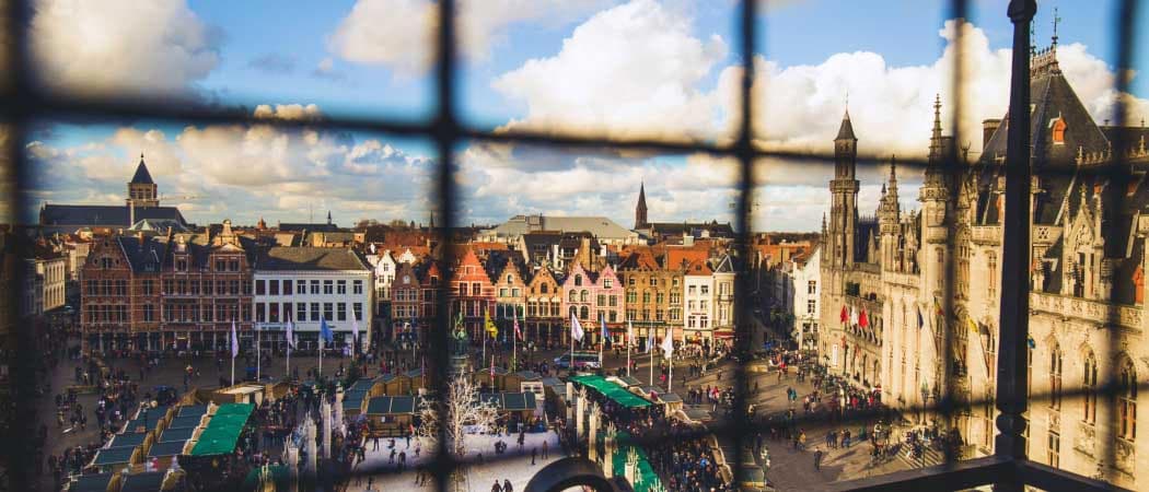 Aerial view of Bruges, Belgium city center, shot through bars of an upper terrace fence.