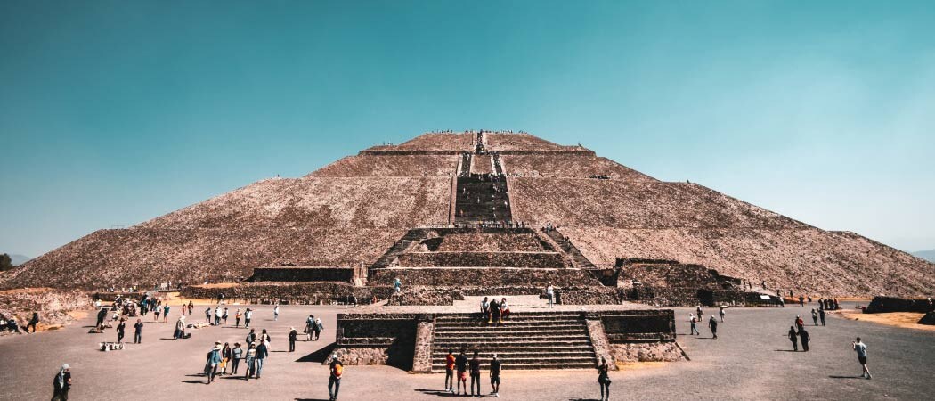 People climb to the top of the Pyramid of the Sun via the many, many stairs leading up the side of the enormous ancient structure.