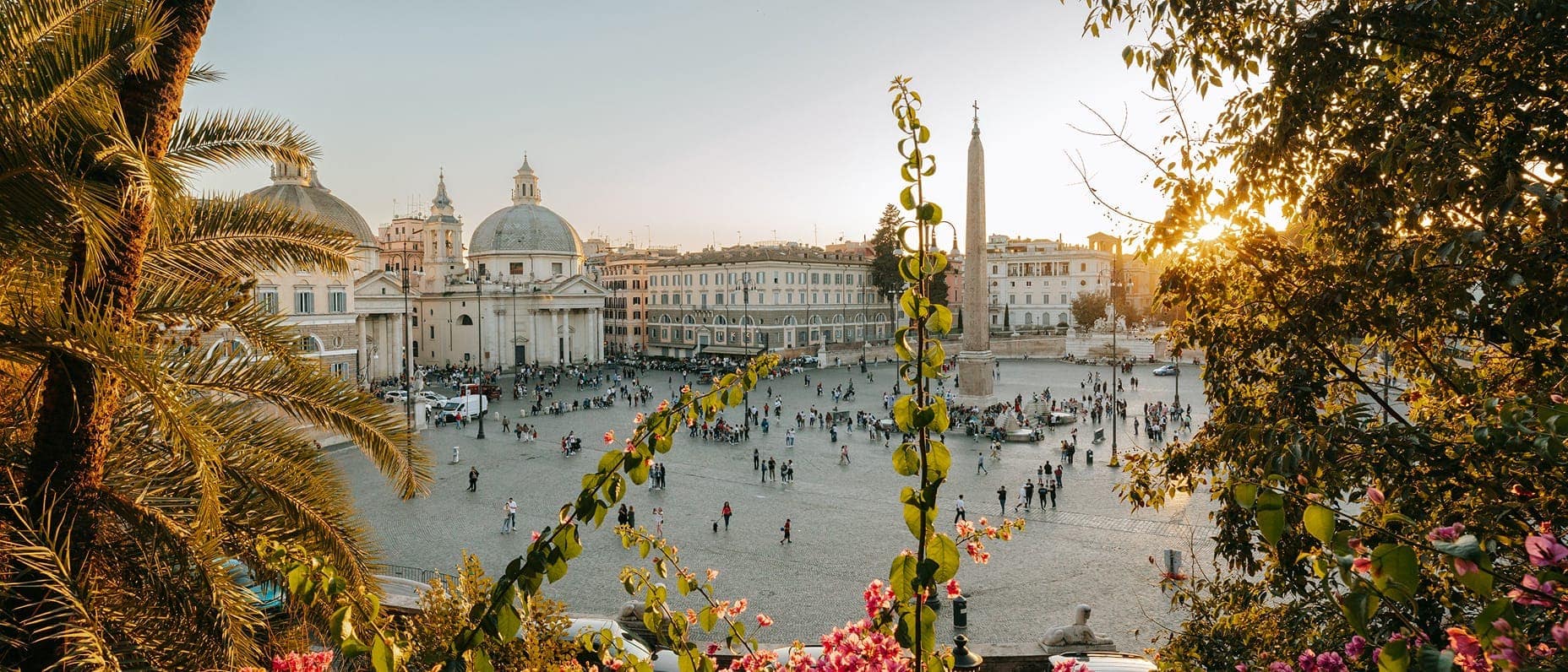 A view out onto a picturesque city square with people milling about.
