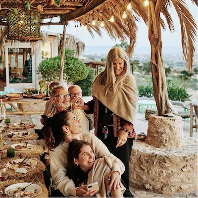 Friends gather to share a meal on the beautiful patio of a vacation home.