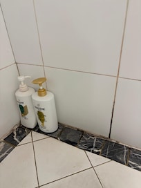 Cracked drain tile which is a danger of cutting anyone showering!
