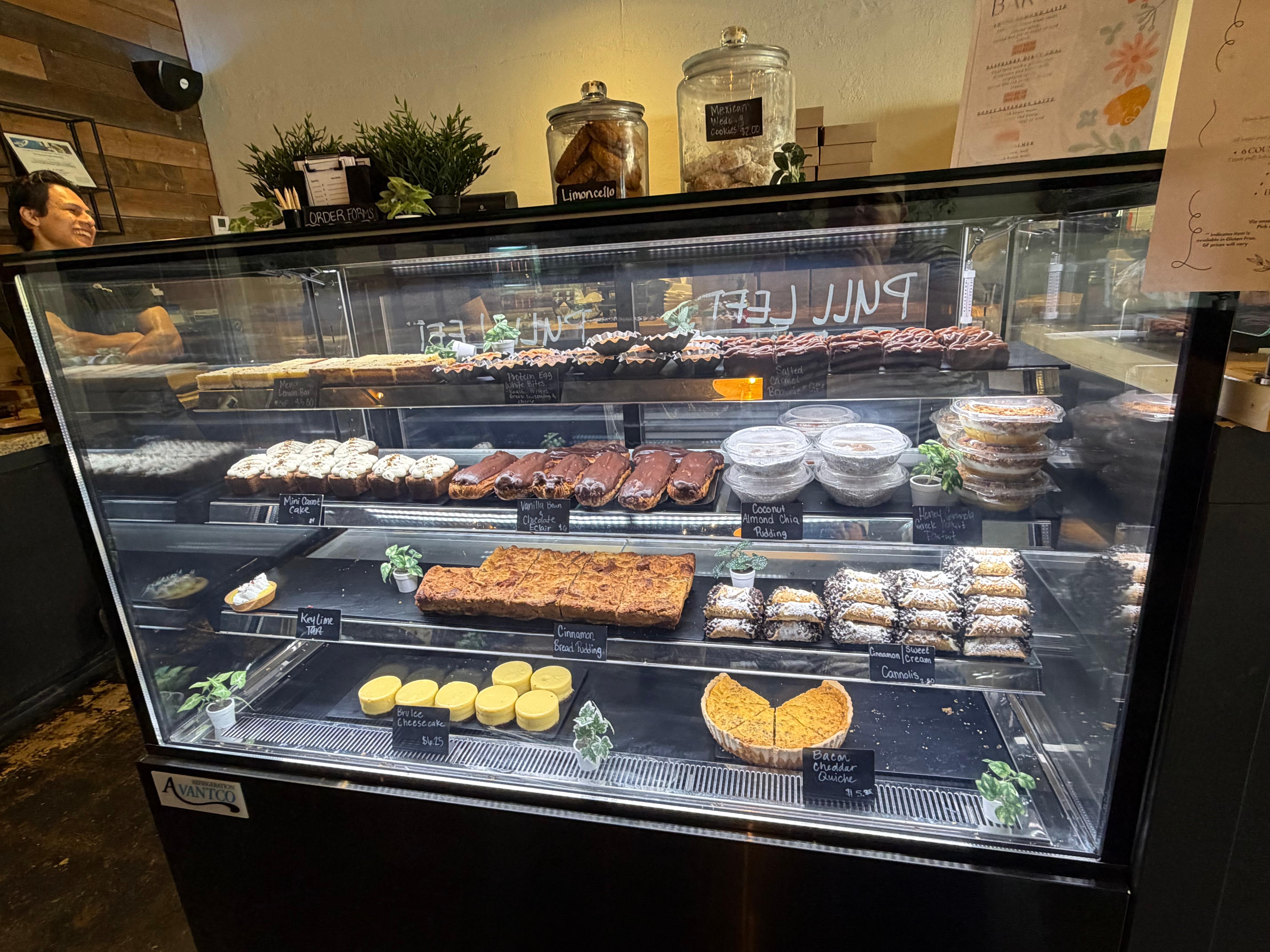 Display case of yummy sweet and savory pastries, bars, cakes, puddings, and tarts at Brûlée Bakery
