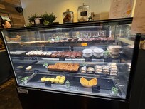Display case of yummy sweet and savory pastries, bars, cakes, puddings, and tarts at Brûlée Bakery