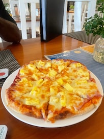 Pineapple pizza with fresh pineapple. Yum.