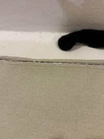 Behind the couch cushion