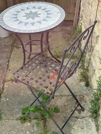 Outdoor space with rusty chairs.