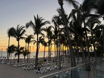Sunset view from the pool deck. There are cabanas to the leff
