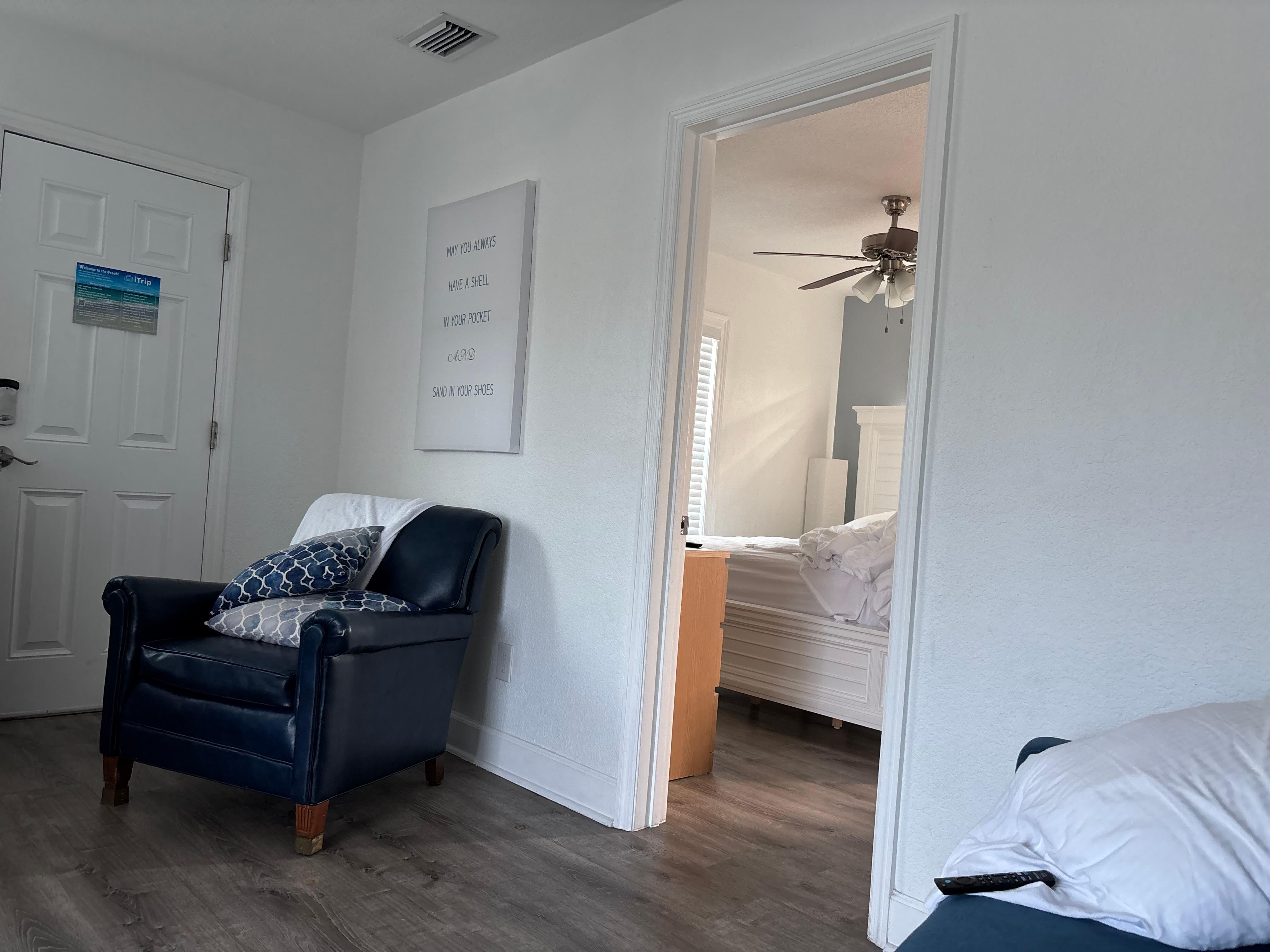 View from living room couch, shows bedroom to the right. 