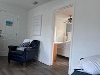 View from living room couch, shows bedroom to the right.