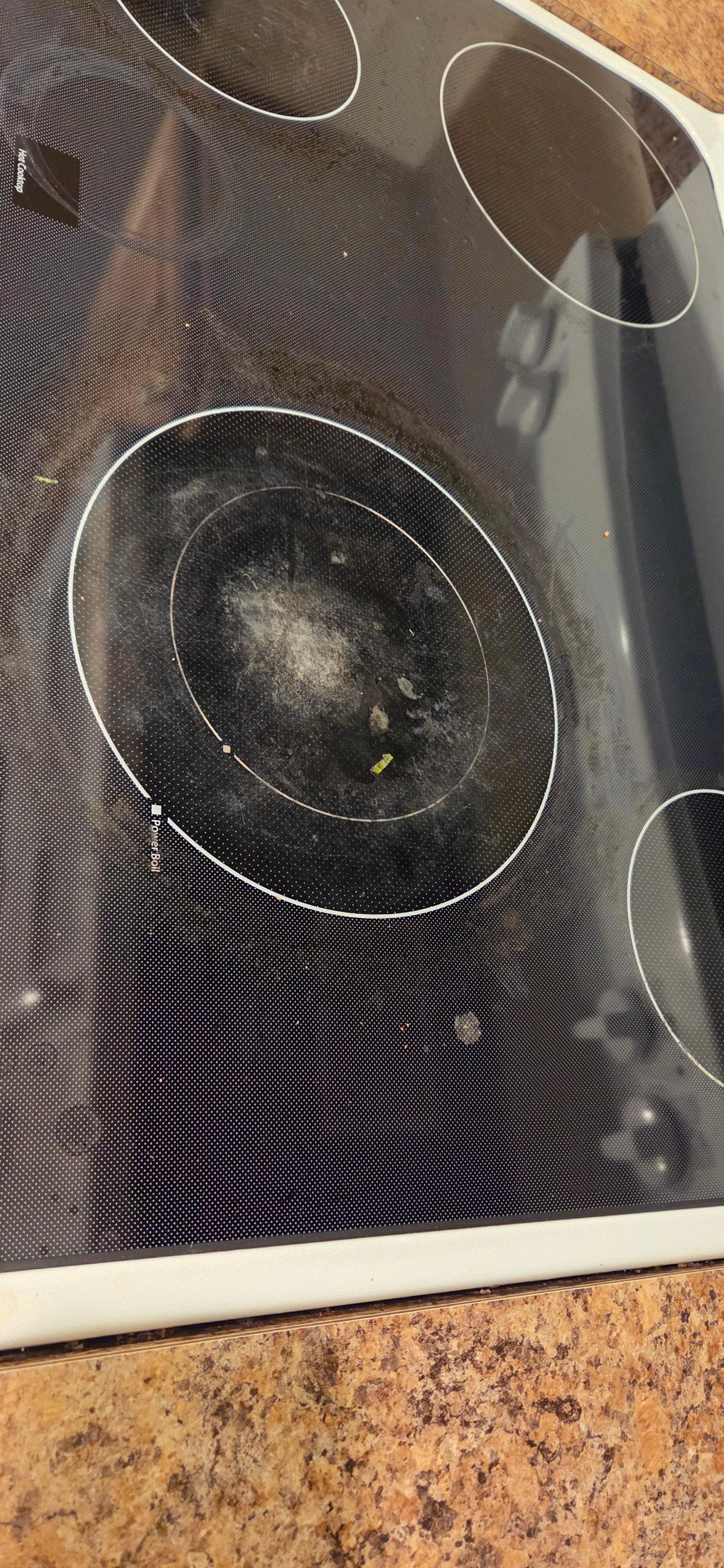 Dirty stovetop with stuck on food. 