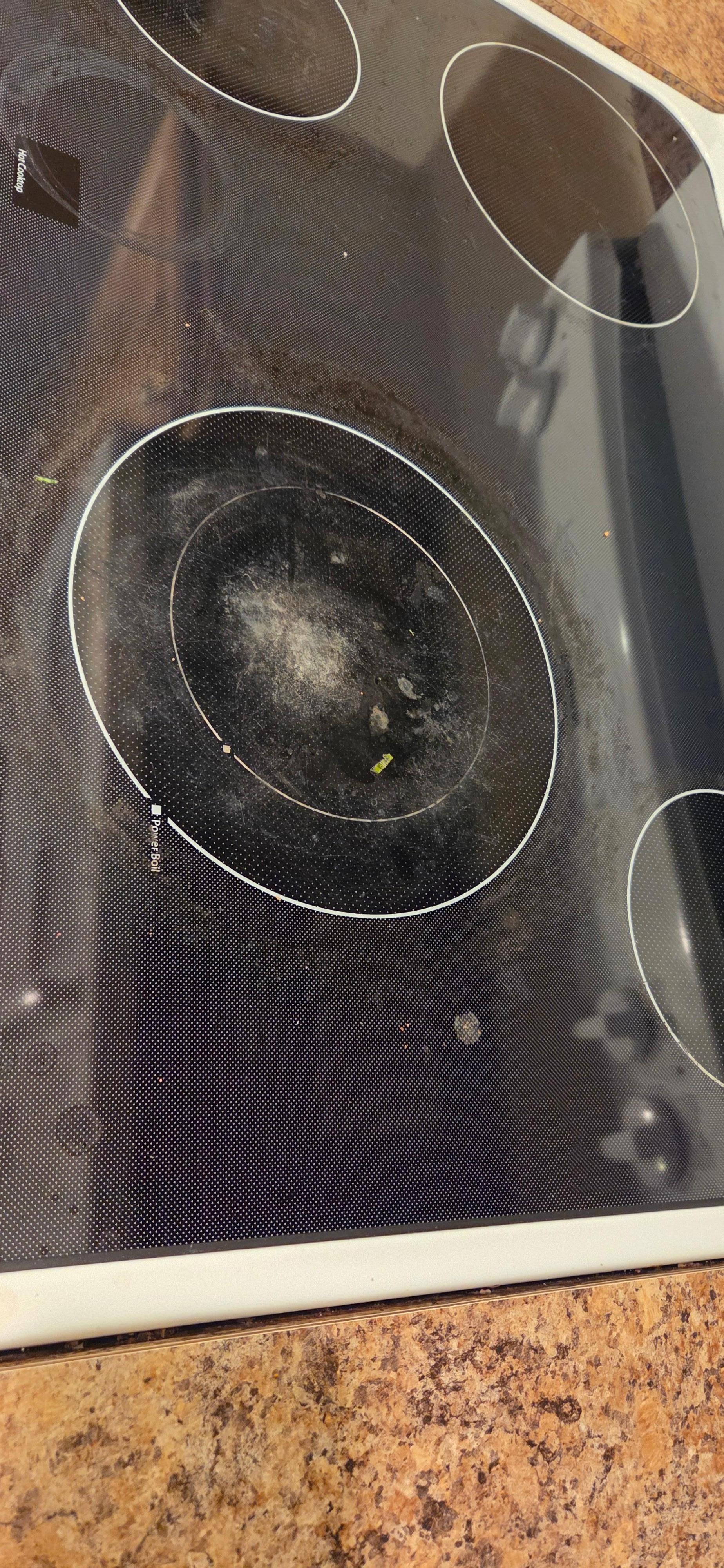 Dirty stovetop with stuck on food.