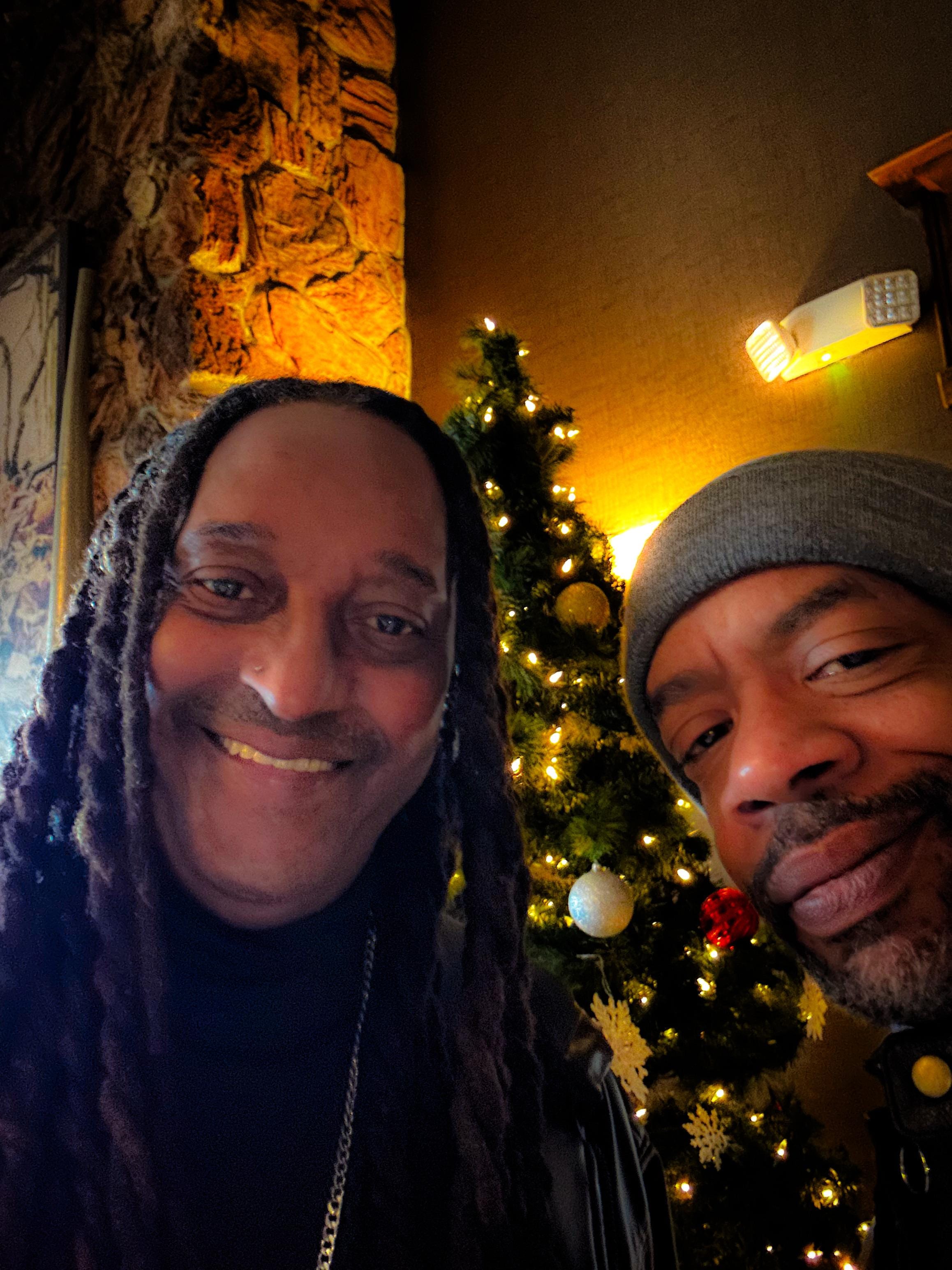 Standing by the tree in the lobby 