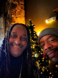 Standing by the tree in the lobby