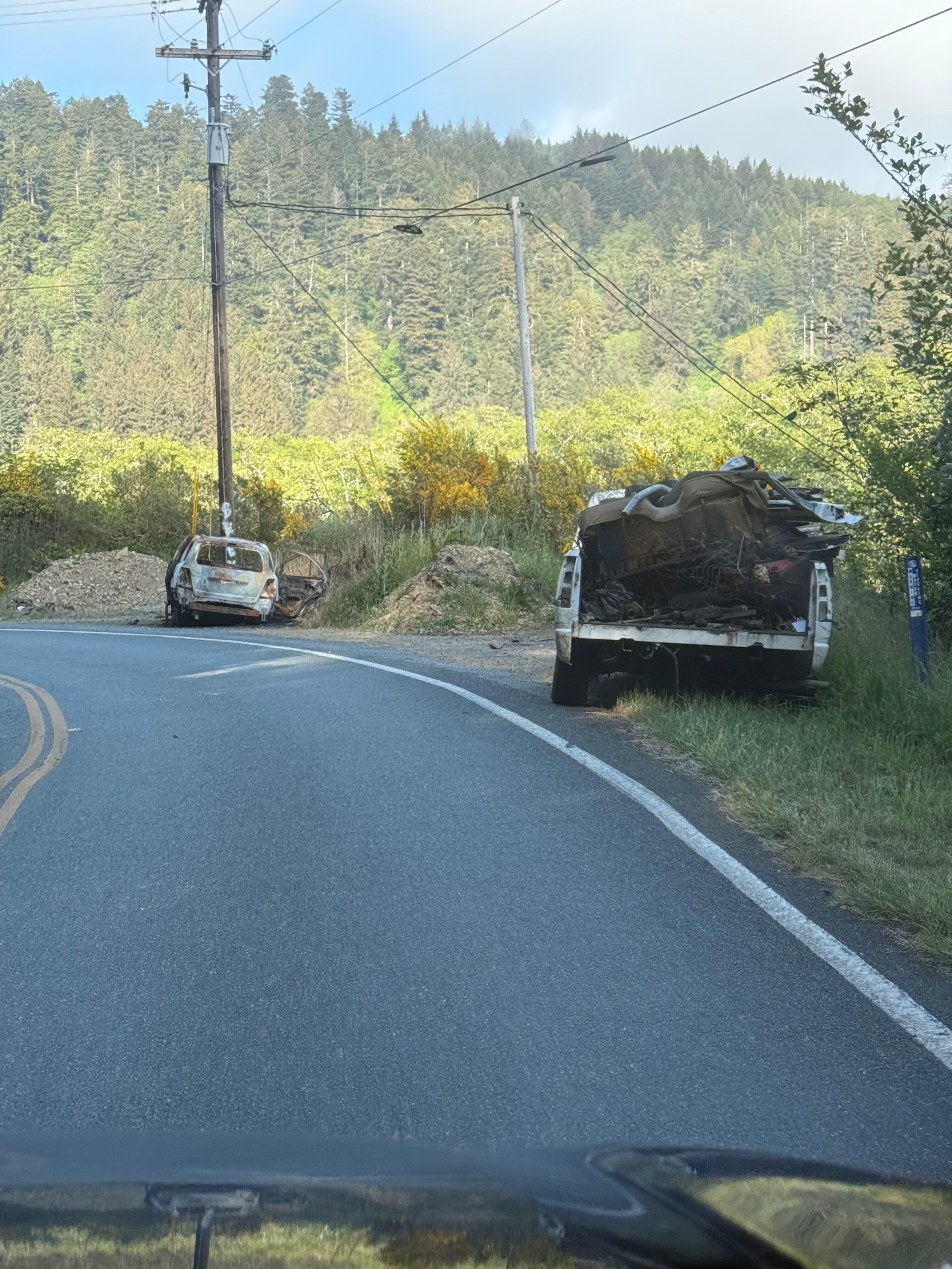 Abandoned vehicles on road before reaching the inn. 