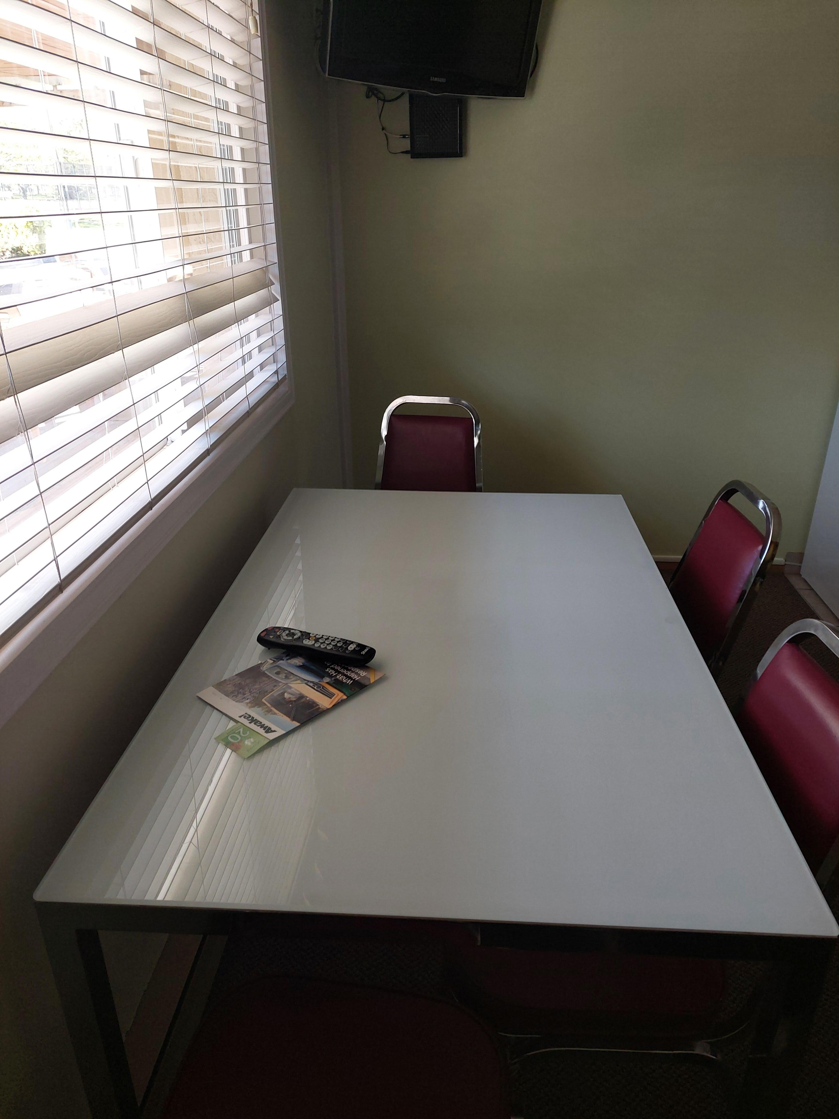Large dining table with TV in livingroom and TV in bedroom 