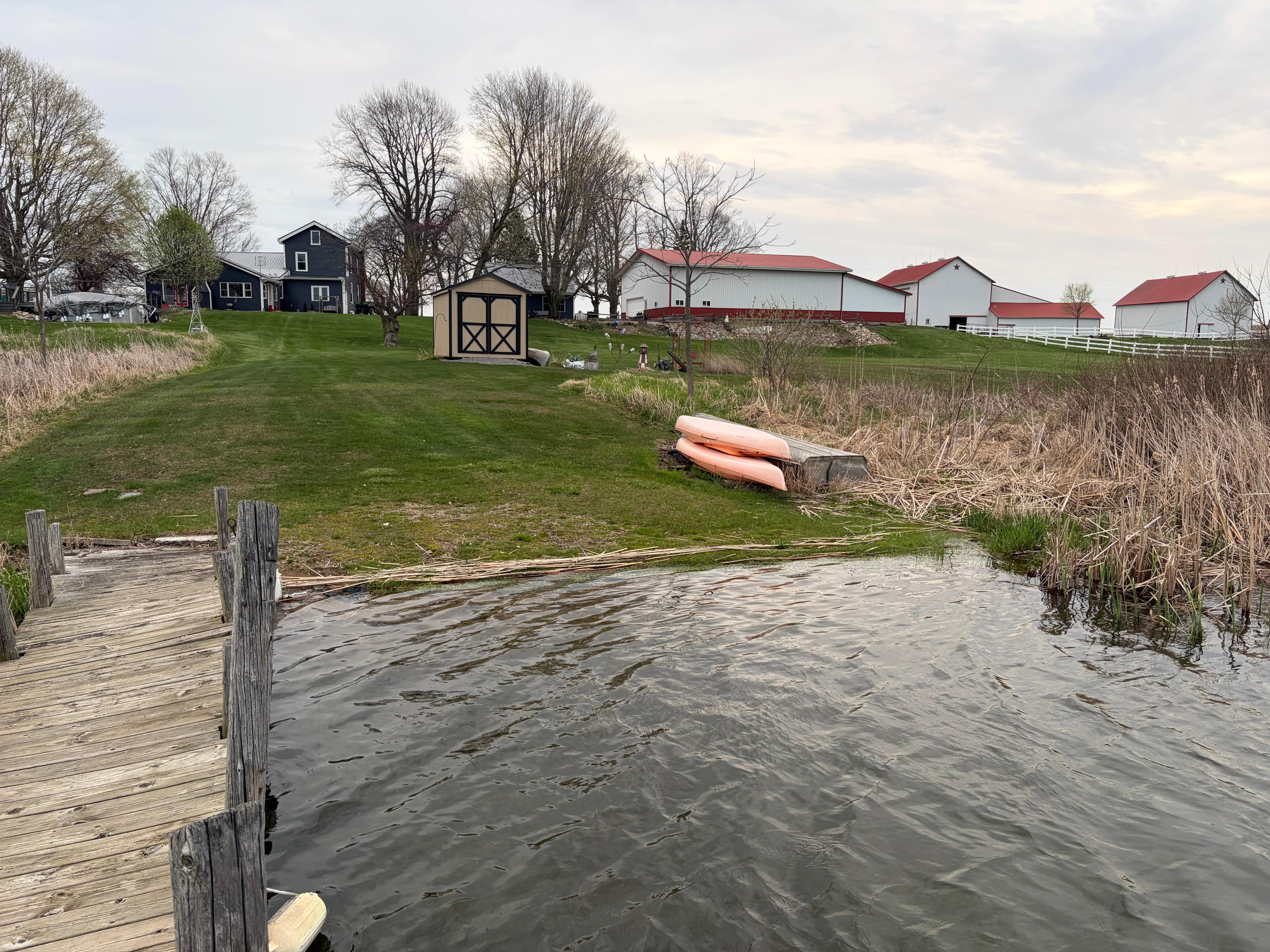 On the dock with owners house on the left, cottage behind the shed and barns to the right.