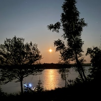 The “strawberry moon” and dock in the early evening.