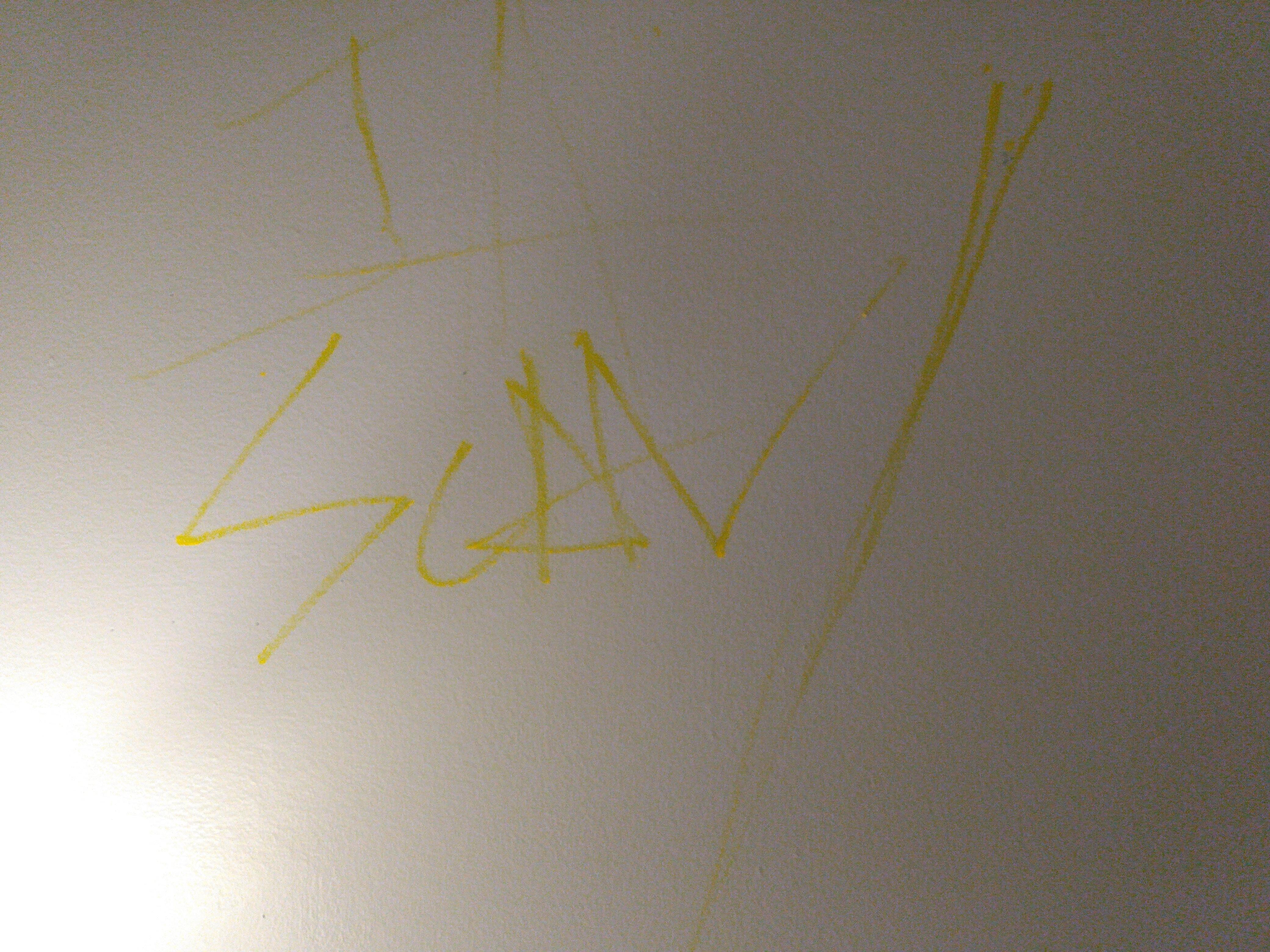 This graffiti was on the wall above a lamp (one of three such markings).