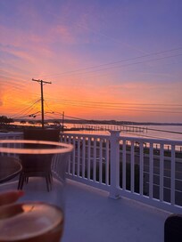 Enjoying a drink on the top balcony off the master bedroom