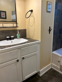 Bathroom. Pull out magnifying mirror could be put on the left side of the sink.
