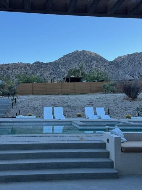 This is a picture of the mobile home and other structures that are butted up to the fence very close to the pool area.  Not private at all. 