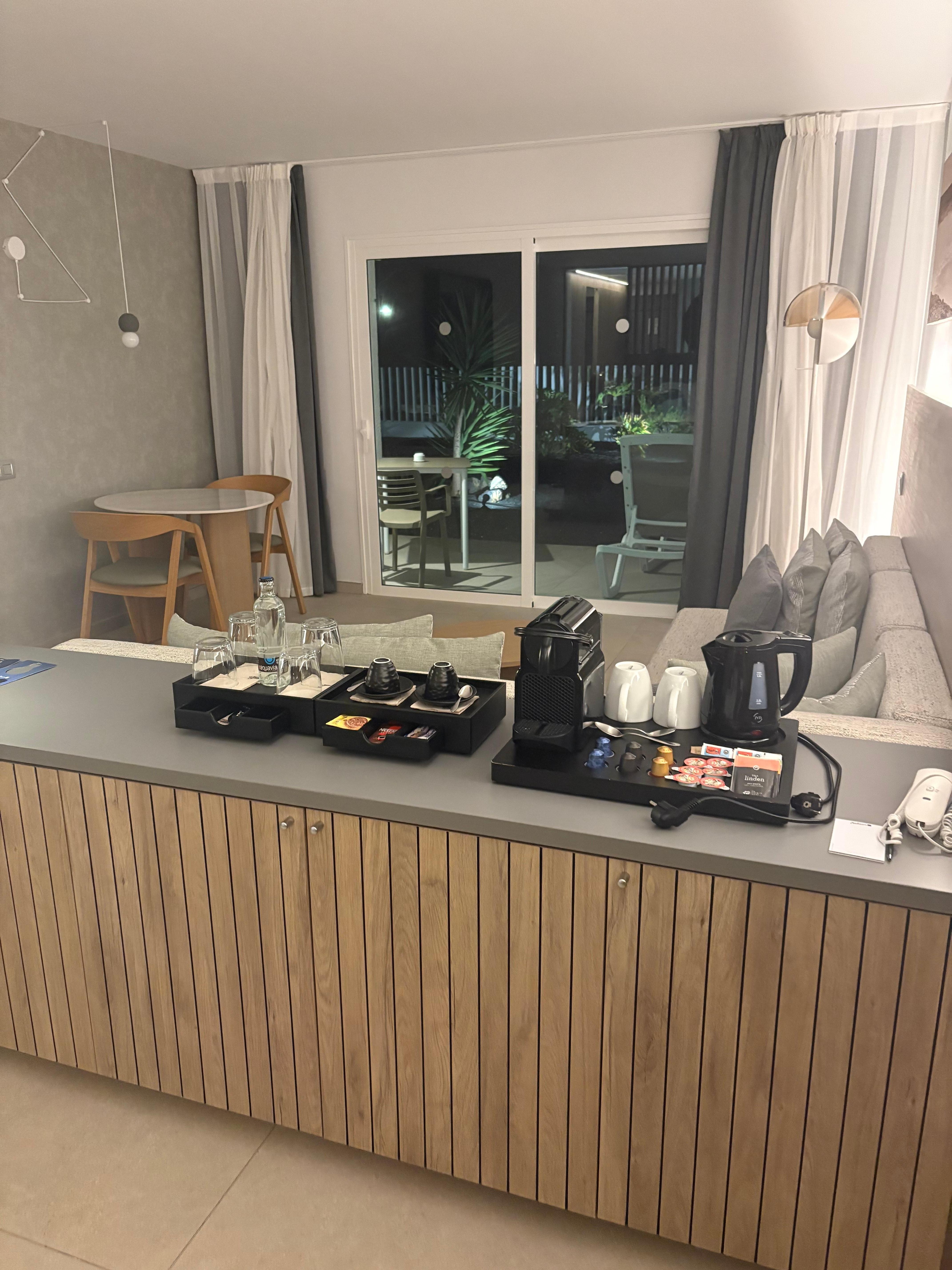 View from side of bed, units storage and minibar