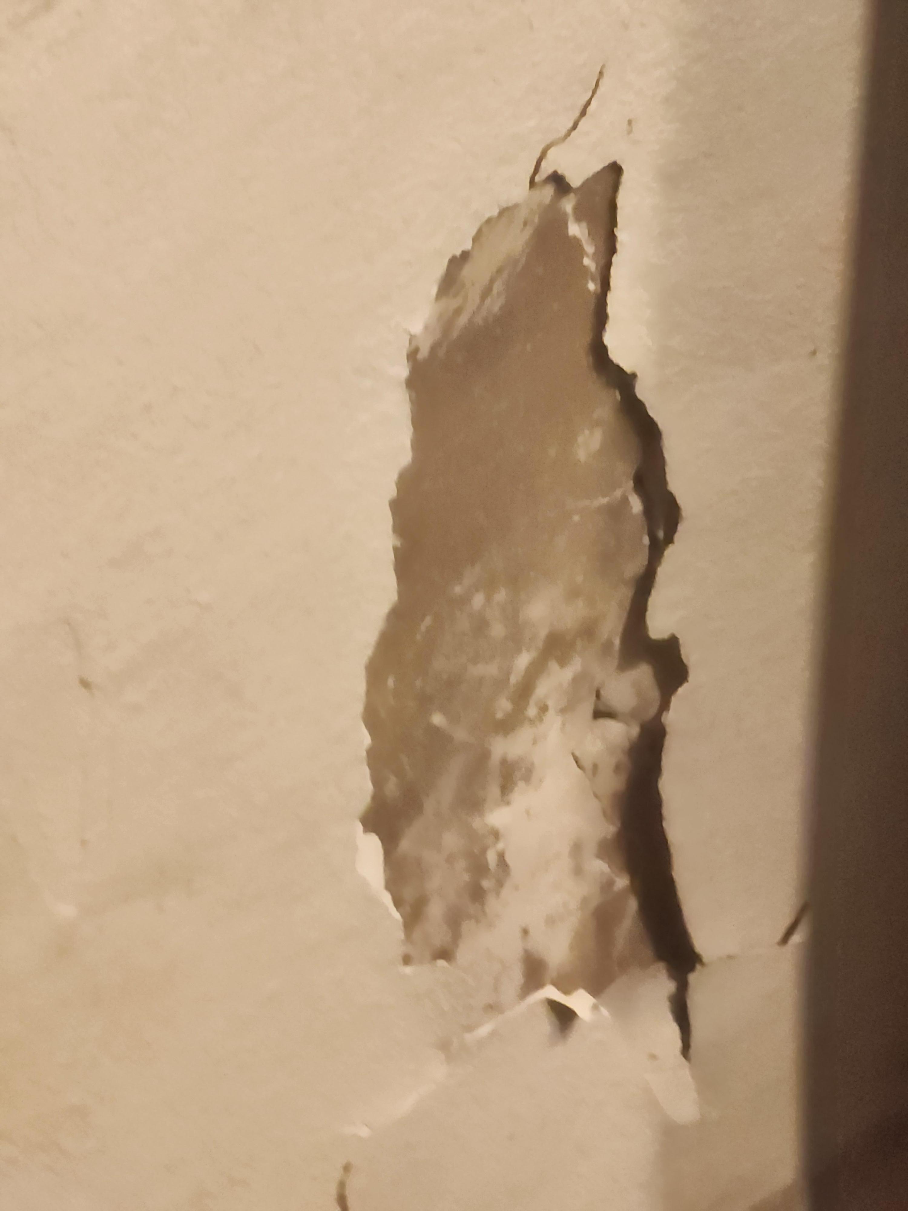 Peeling paint/damage on wall 