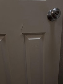 Cracks on the bathroom door painted over