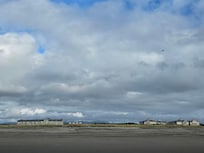 View from beach, condo is 1st floor, to the far left, of the building on the left.