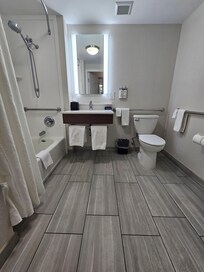 Really nice bathroom with accessible handles and shower bench.