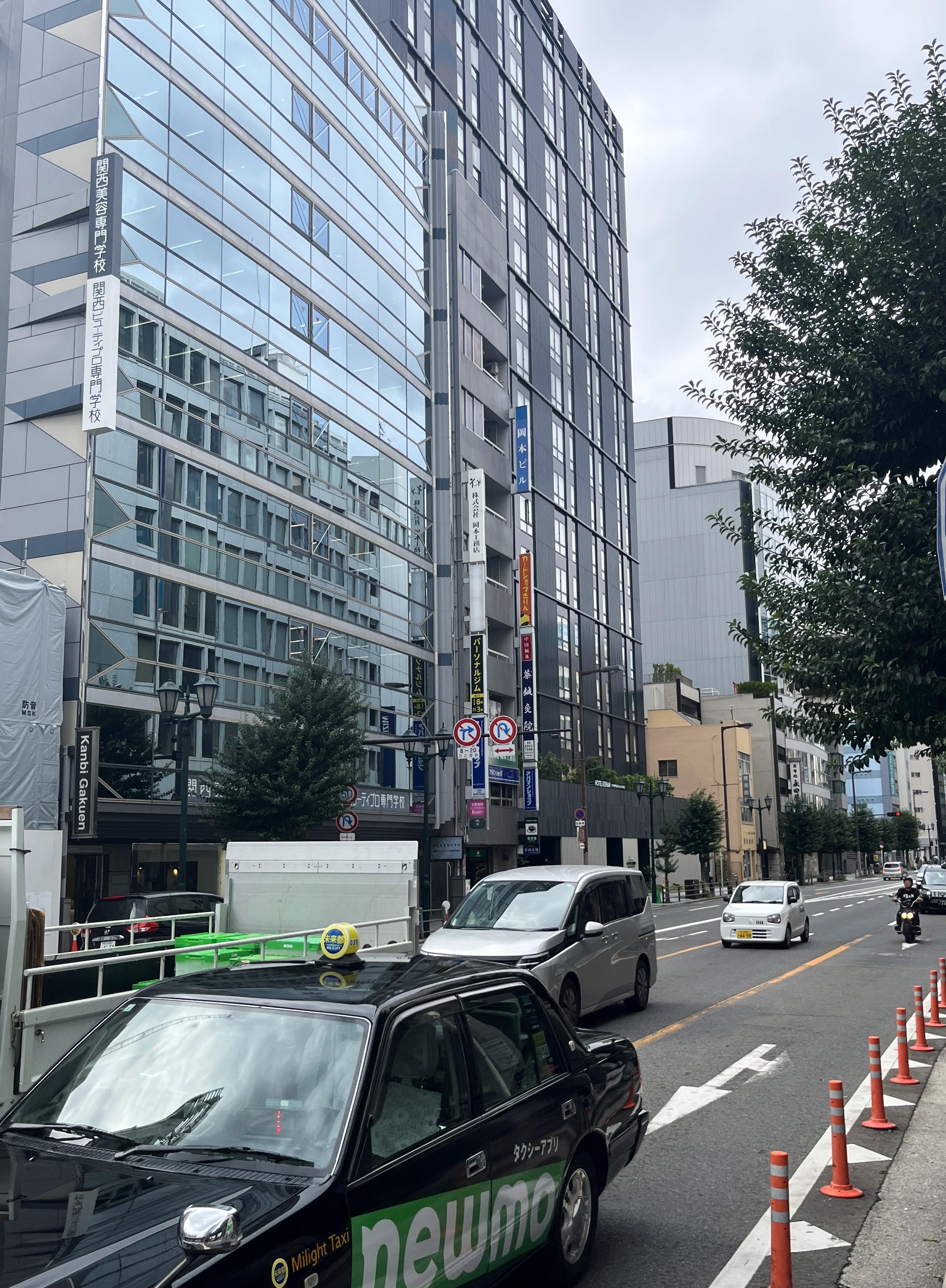 The hotel is the tall, black building