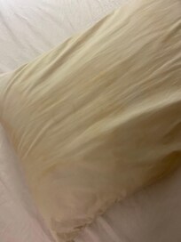 Yellow pillows bed not made look like someone just checked out and they checked us in without even cleaning the room