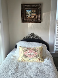 One of the twin beds in the front room.