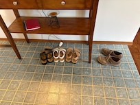 Table in entry way. Sign on it says, This is a shoe free house.