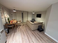 Living area with no rug, different lamps.