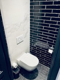 Seperate enclosed loo from bathroom shower and sink area.