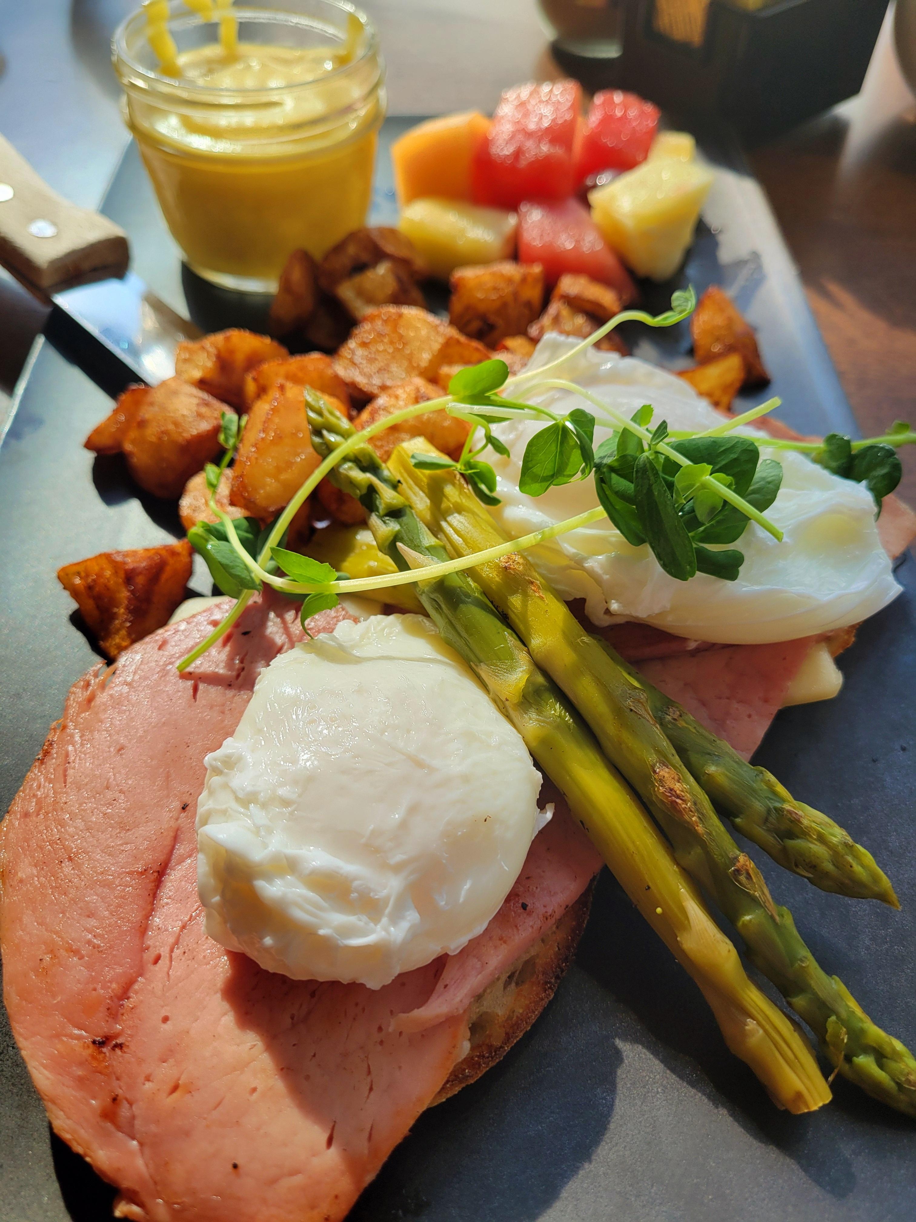 Eggs benedict with asparagus, ham and swiss cheese.