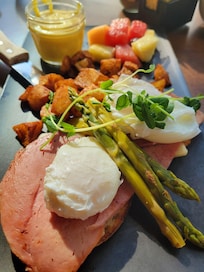 Eggs benedict with asparagus, ham and swiss cheese.