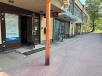The entrance is actually on the side of the building, but it takes you into that spiral staircase that goes up to the restaurant. Your room code opens the door at the back of the building that will get you to the elevator with minimal stairs.