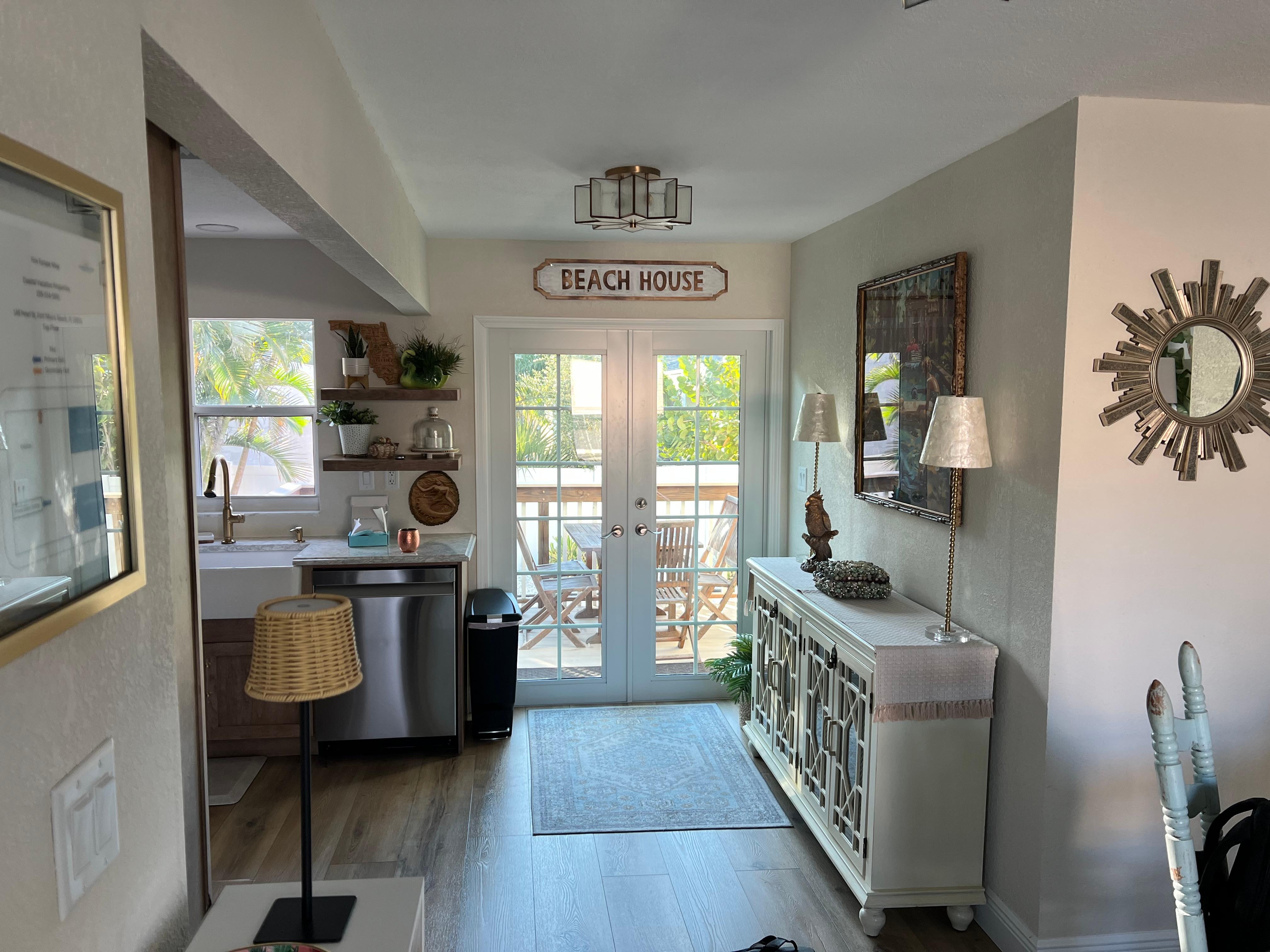 View from front door with kitchen on left & double doors out to patio/pool
