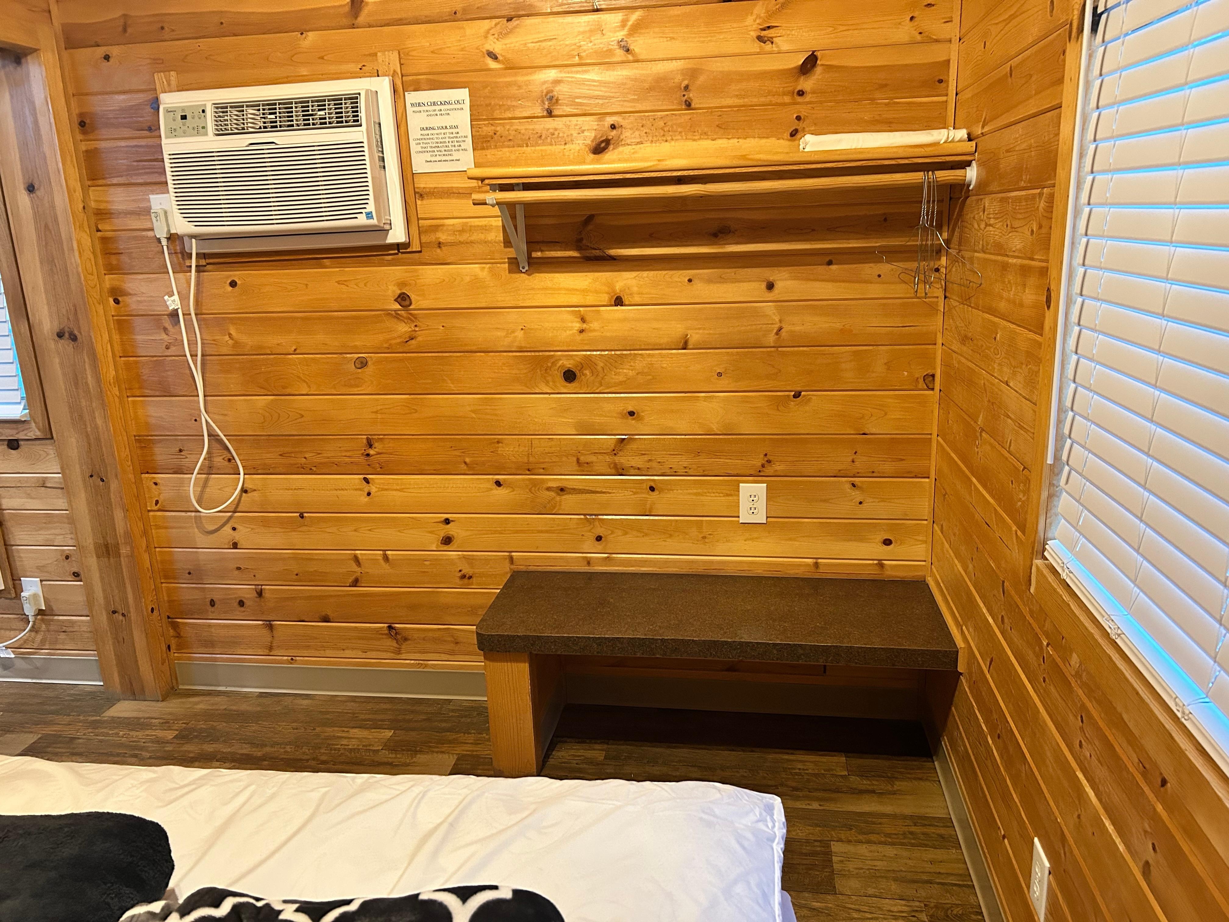 Clothes rack and bench in master bedroom.
